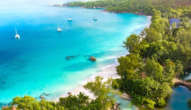 Seychelles Sun-Soaked Sailing: A Pristine Beach Experience from Praslin in Baie Ste Anne